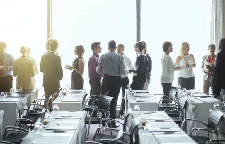Diverse group of professionals collaborating in a modern meeting room.