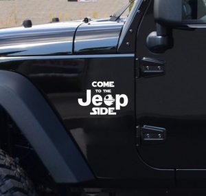 Collection of colorful Jeep decals and stickers featuring mountain graphics, trail logos, and off-road designs