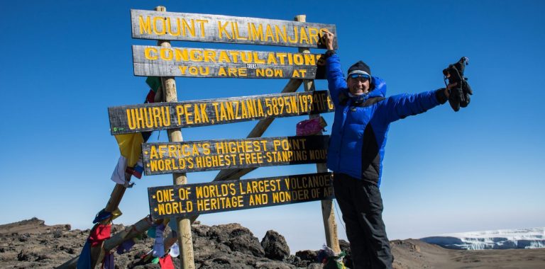 Snowy summit of Mount Kilimanjaro with rugged volcanic peaks and panoramic views of the African plains.