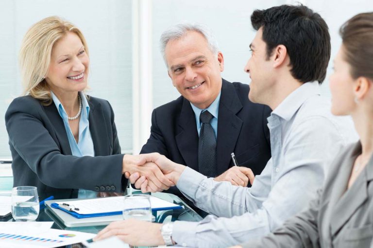 Close-up of two businesspeople shaking hands to seal a deal