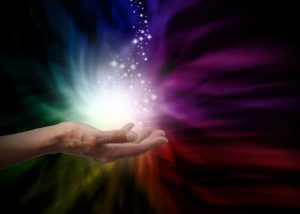 Teal Swan leading a spiritual healing session, hands raised, surrounded by soft light.